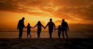 Family on the beach at sunset